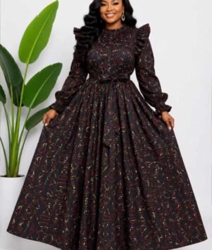 Woman wearing a black, red and gold abstract African print two-piece top and maxi skirt set