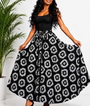 Woman wearing a black and white batik circle African print high-waisted pleated maxi skirt