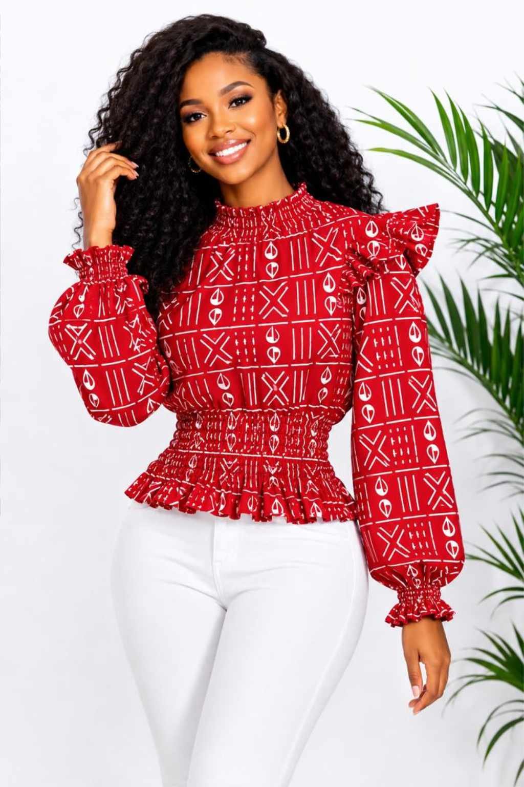 Woman wearing a red and white mudcloth bogolan African print ruffle peplum top