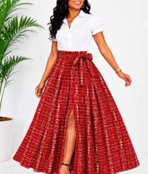 Woman wearing a red and white mudcloth bogolan African print high-waisted pleated maxi skirt