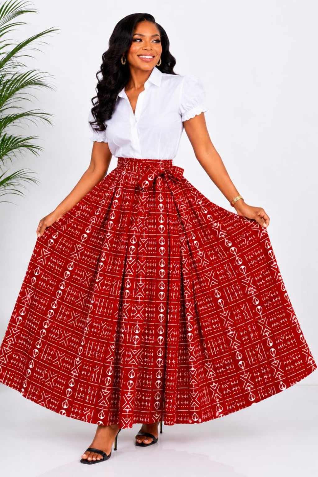 Red & White Mudcloth African Print Maxi Skirt 2 Woman wearing a red and white mudcloth bogolan African print high-waisted pleated maxi skirt - without split view