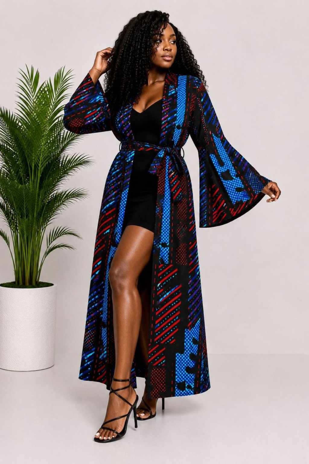 Woman wearing a blue, red and purple abstract African print long kimono duster with bell sleeves