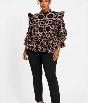 Woman wearing a white, red and black circle batik African print ruffle peplum top
