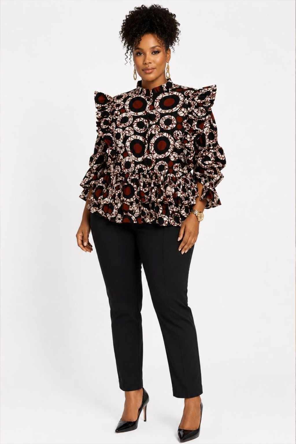 Woman wearing a white, red and black circle batik African print ruffle peplum top