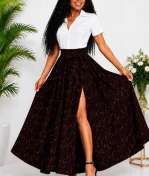 Woman wearing a black, red and gold abstract African print high-waisted pleated maxi skirt