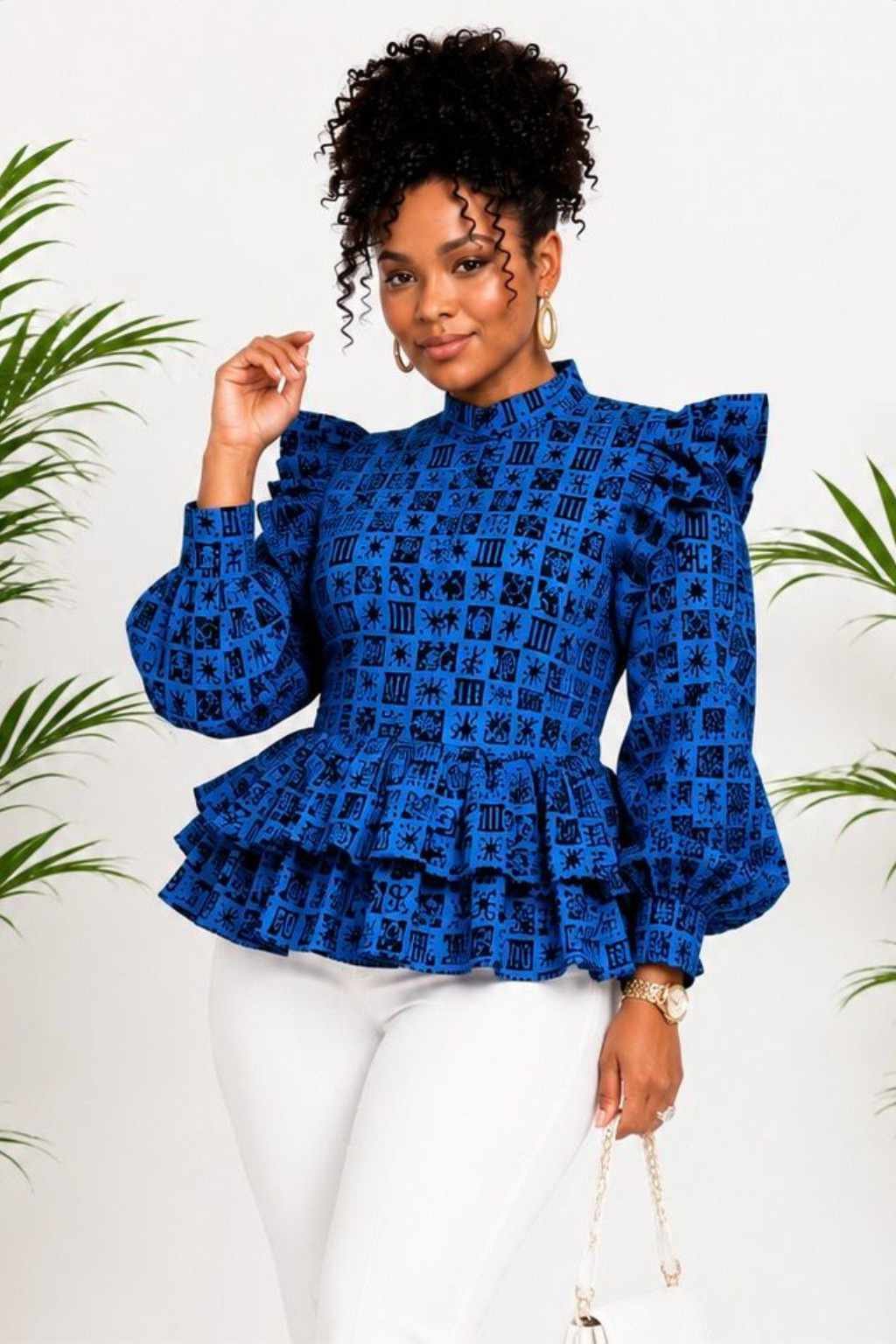 Woman wearing a blue and black tribal African print ruffle peplum top