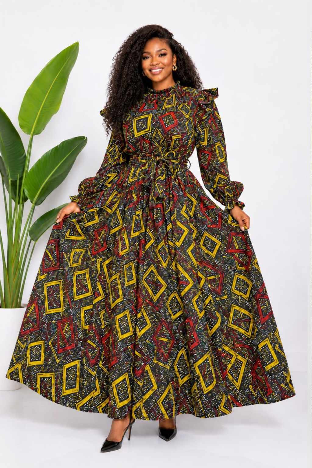 Woman wearing a black, gold and red geometric diamond African print two-piece top and maxi skirt set