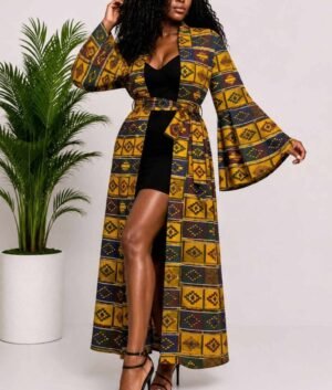 Woman wearing a mustard gold kente-style geometric African print long kimono duster with bell sleeves