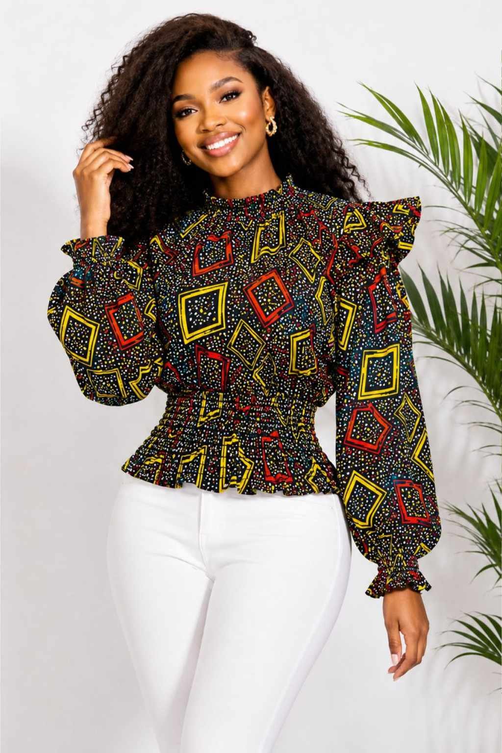 Woman wearing a black, red and yellow geometric African print ruffle peplum top