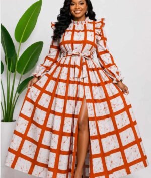 Woman wearing a rust orange and cream windowpane check African print two-piece top and maxi skirt set