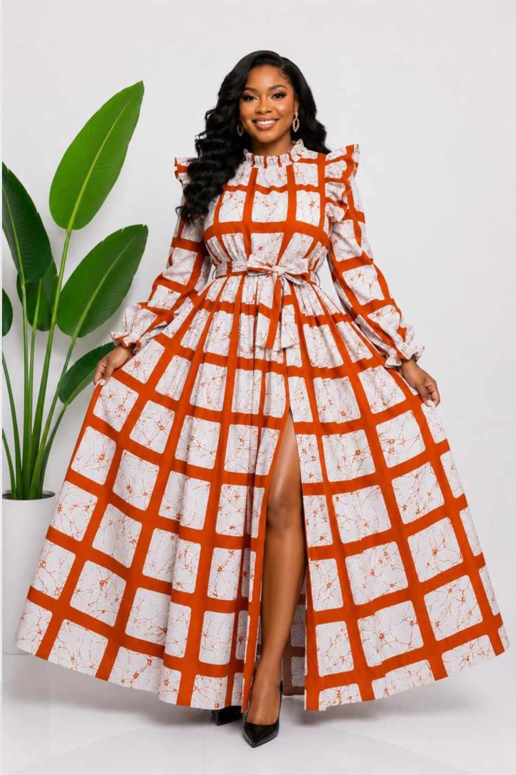 Woman wearing a rust orange and cream windowpane check African print two-piece top and maxi skirt set