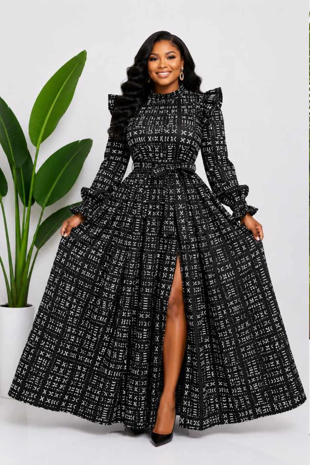 Woman wearing a black and white mudcloth bogolan African print two-piece top and maxi skirt set