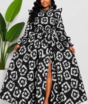 Woman wearing a black and white batik adire circular medallion African print two-piece top and maxi skirt set