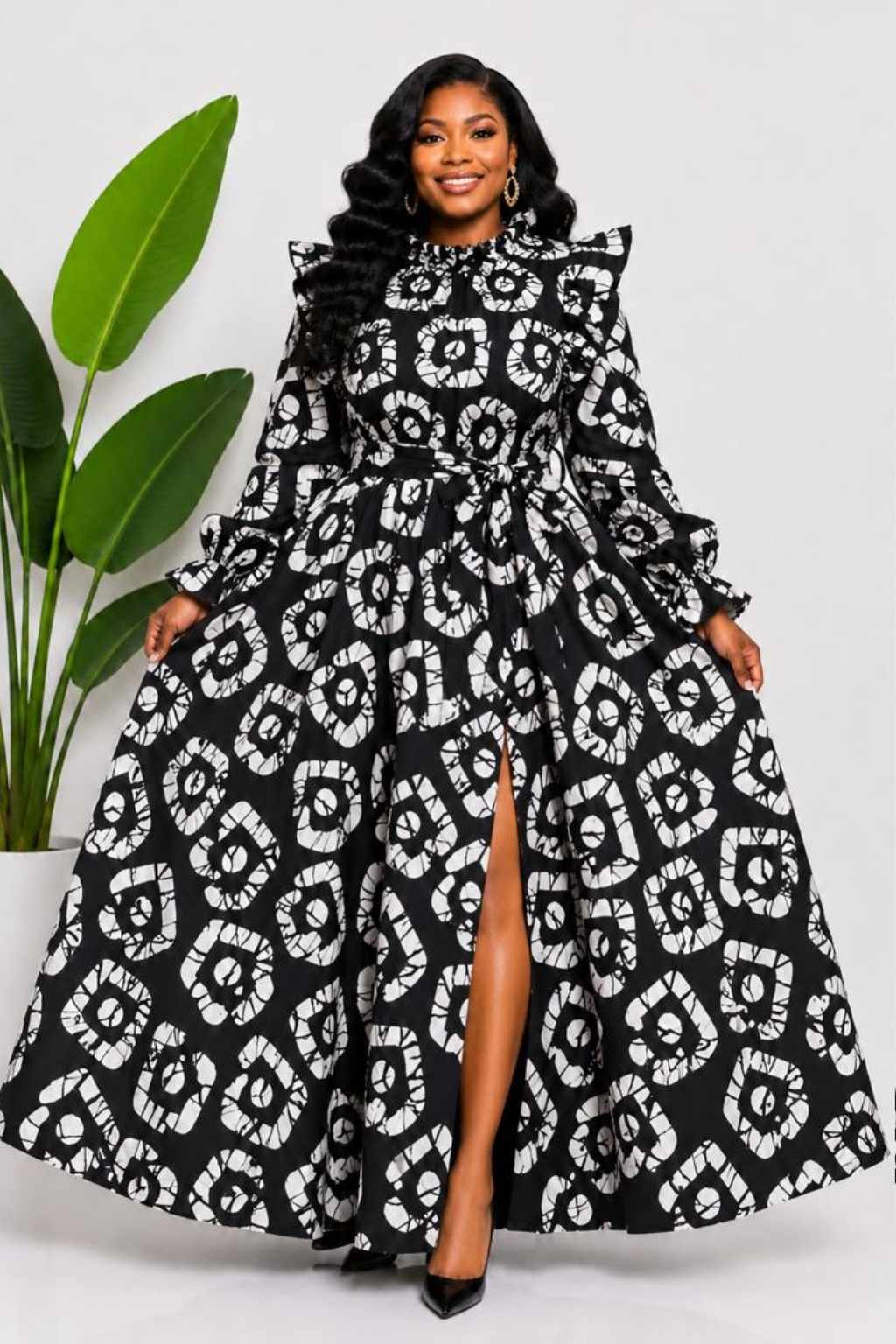 Woman wearing a black and white batik adire circular medallion African print two-piece top and maxi skirt set