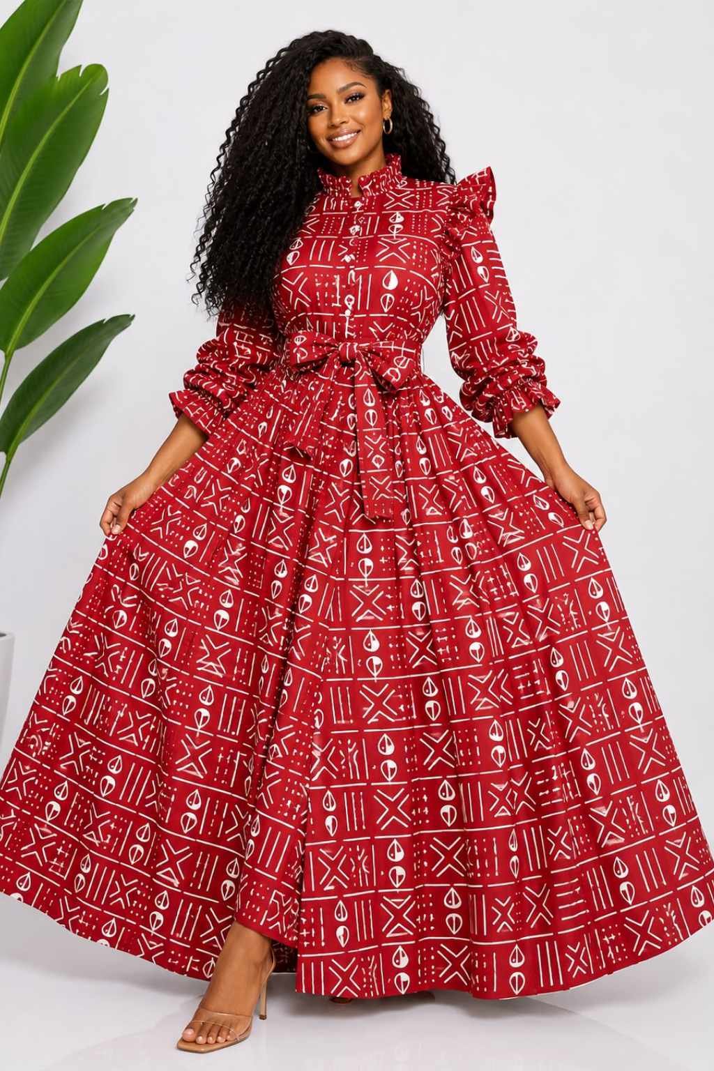 Woman wearing a red and white mudcloth bogolan African print two-piece top and maxi skirt set