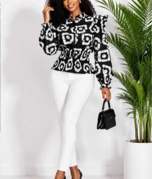 Woman wearing a black and white batik circle African print ruffle peplum top