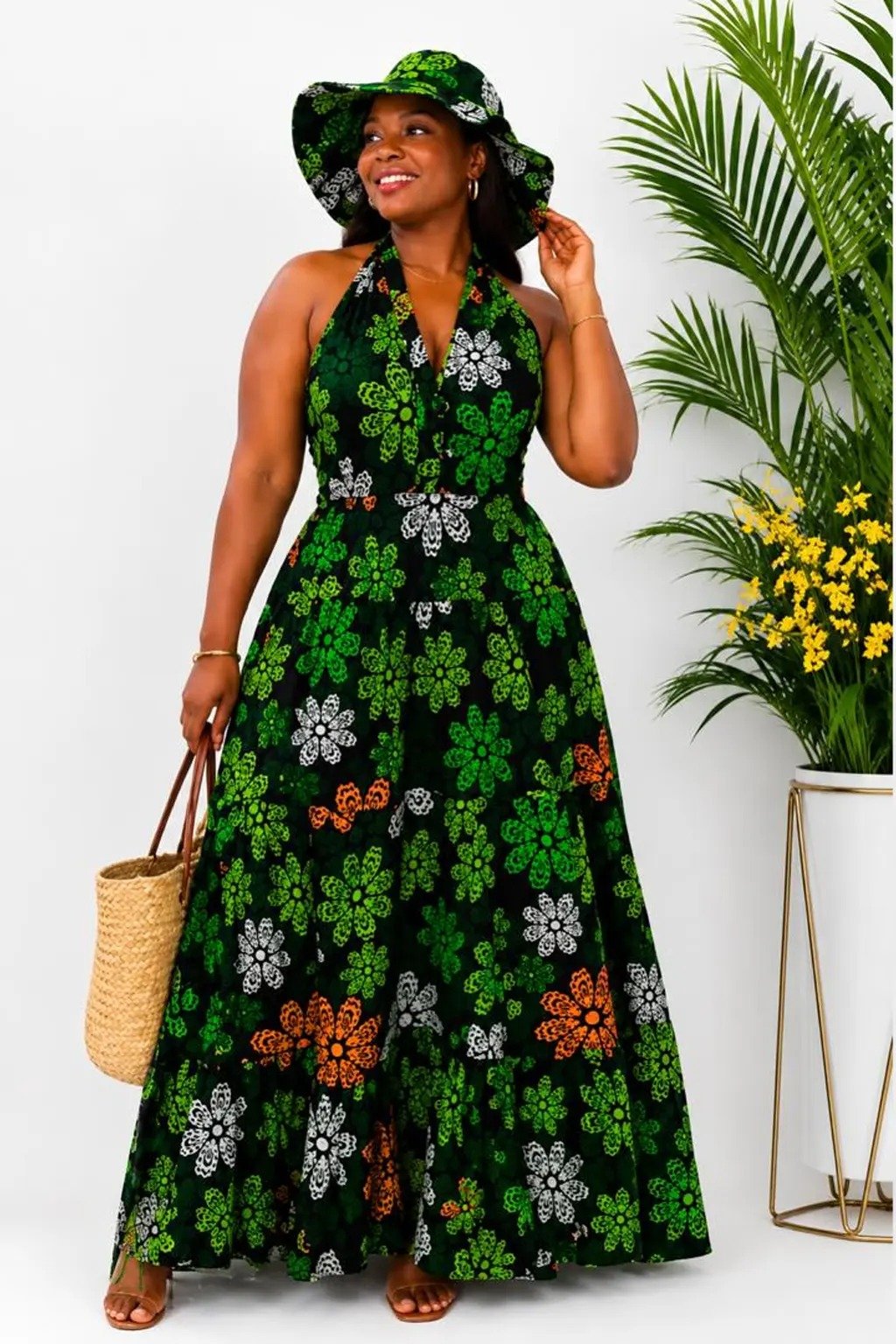 Woman wearing a green floral African print halter-neck maxi dress
