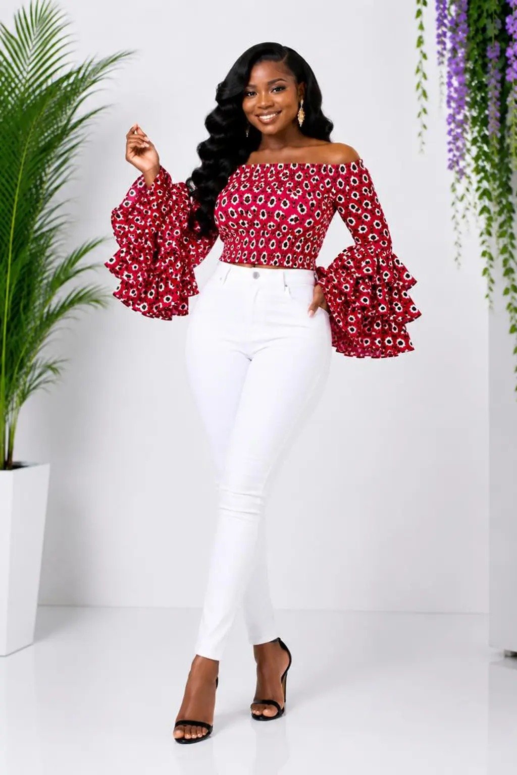 Red Floral African Print Off-Shoulder Bell Sleeve Top & Flare Pants Set 4 Woman wearing a red floral African print off-shoulder bell-sleeve top and flare-leg pants set - view 4