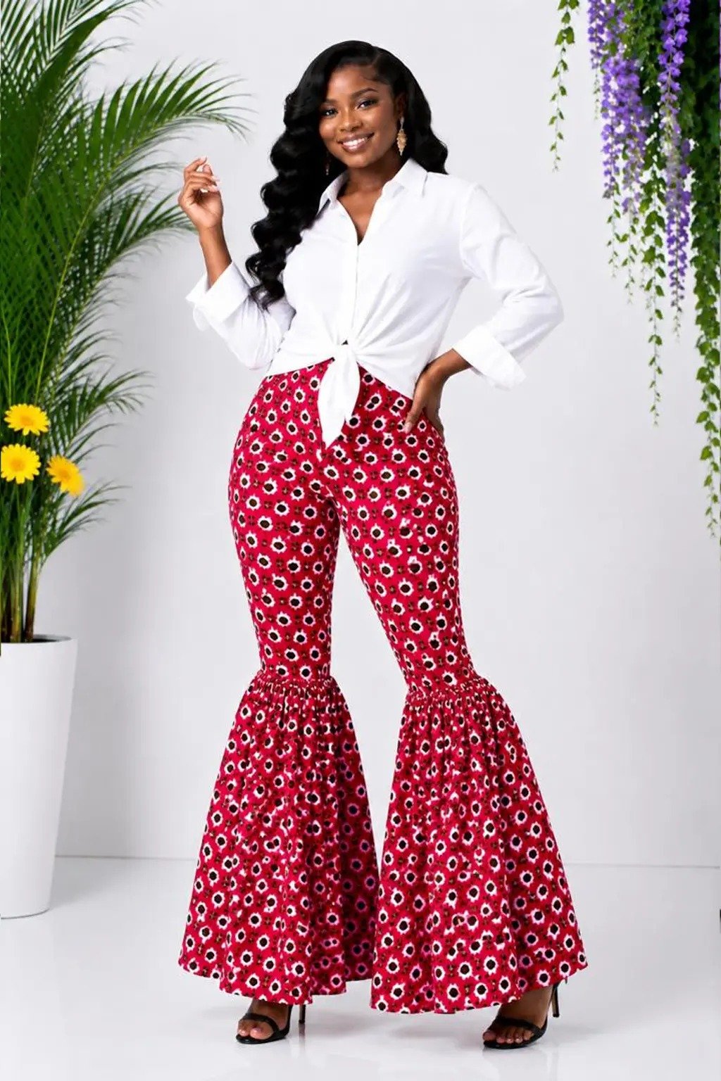 Red Floral African Print Off-Shoulder Bell Sleeve Top & Flare Pants Set 5 Woman wearing a red floral African print off-shoulder bell-sleeve top and flare-leg pants set - view 5
