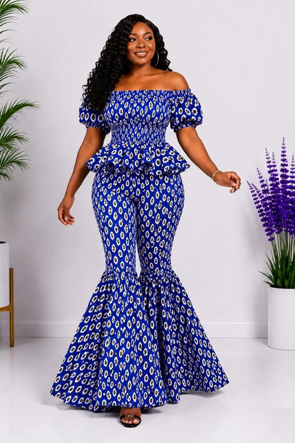 Woman wearing a blue floral African print off-shoulder top and flare-leg pants set - view 2