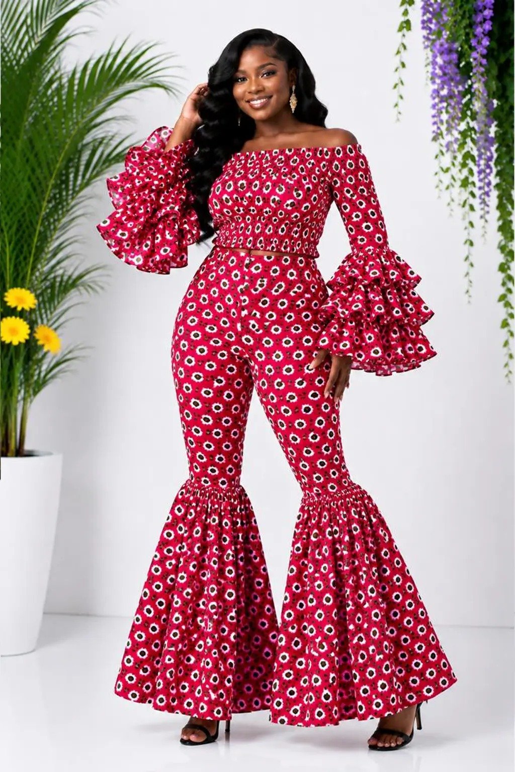 Woman wearing a red floral African print off-shoulder bell-sleeve top and flare-leg pants set