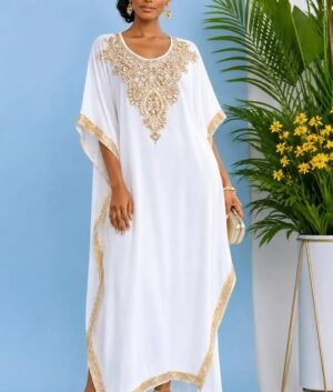 Woman wearing a white gold-embellished kaftan maxi gown