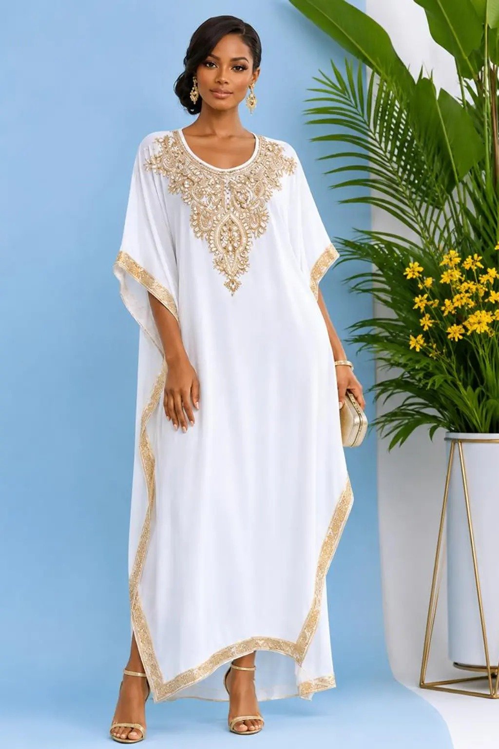 Woman wearing a white gold-embellished kaftan maxi gown