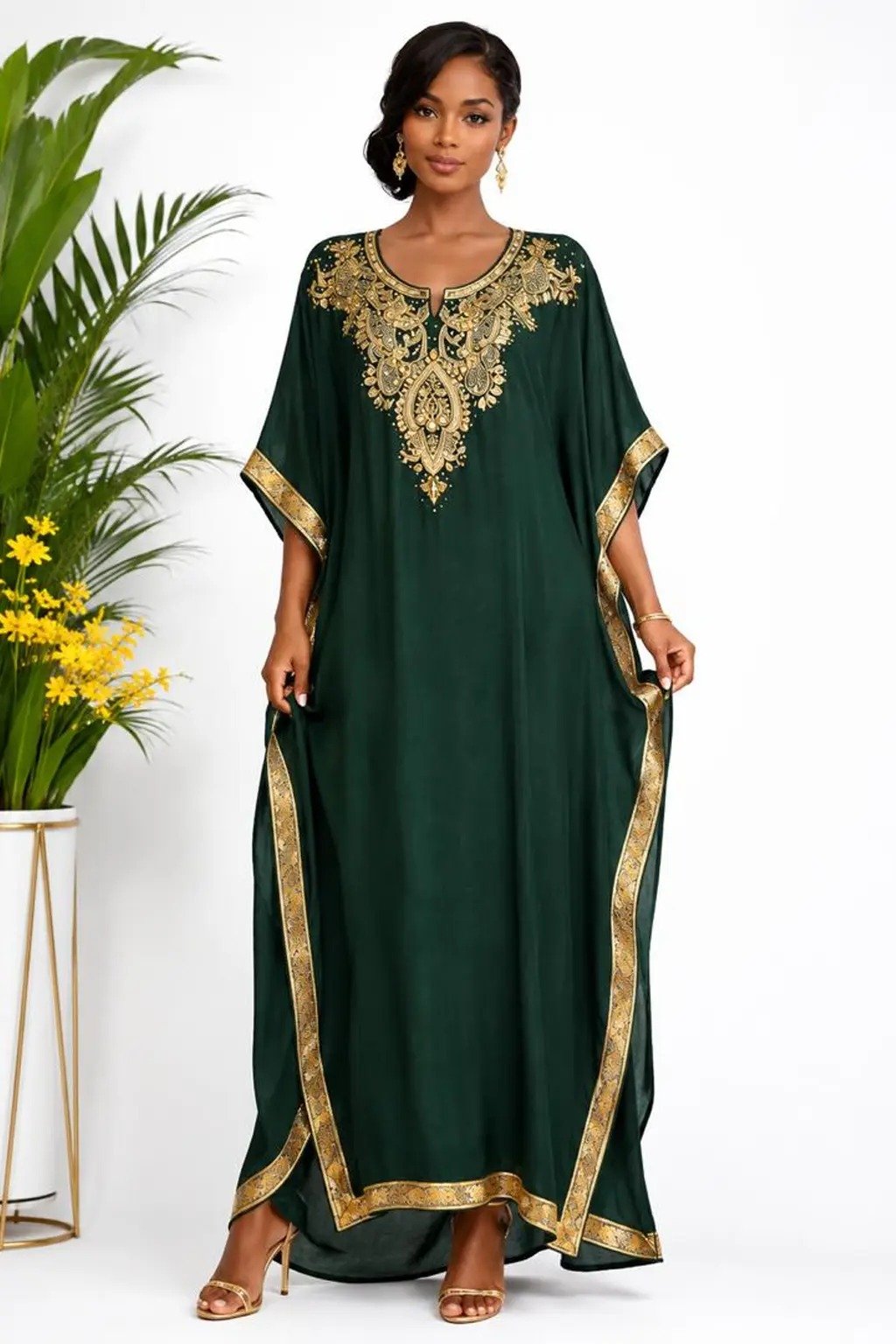 Woman wearing a emerald green gold-embellished kaftan maxi gown