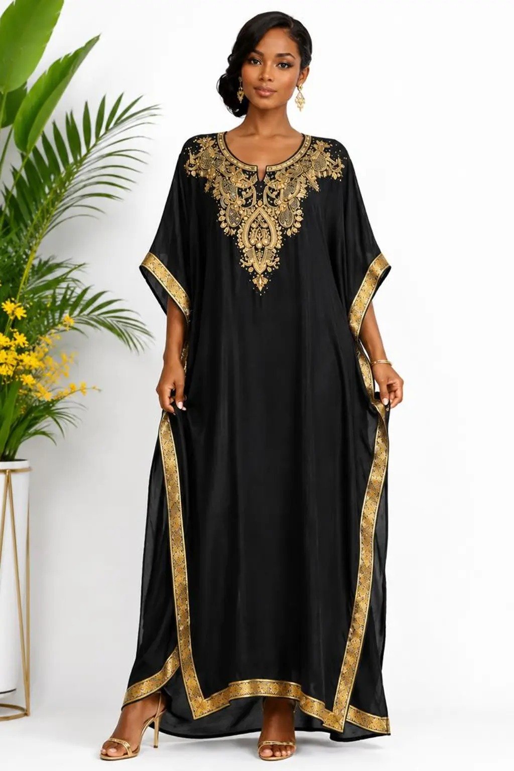 Woman wearing a black gold-embellished kaftan maxi gown
