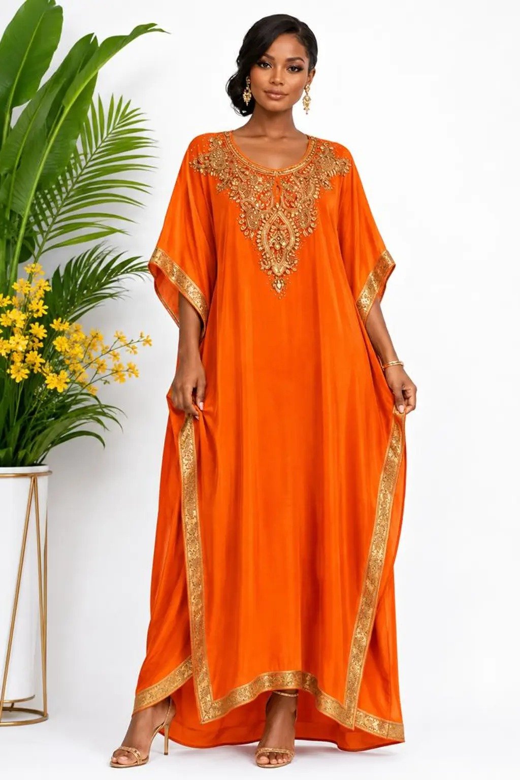 Woman wearing a orange gold-embellished kaftan maxi gown