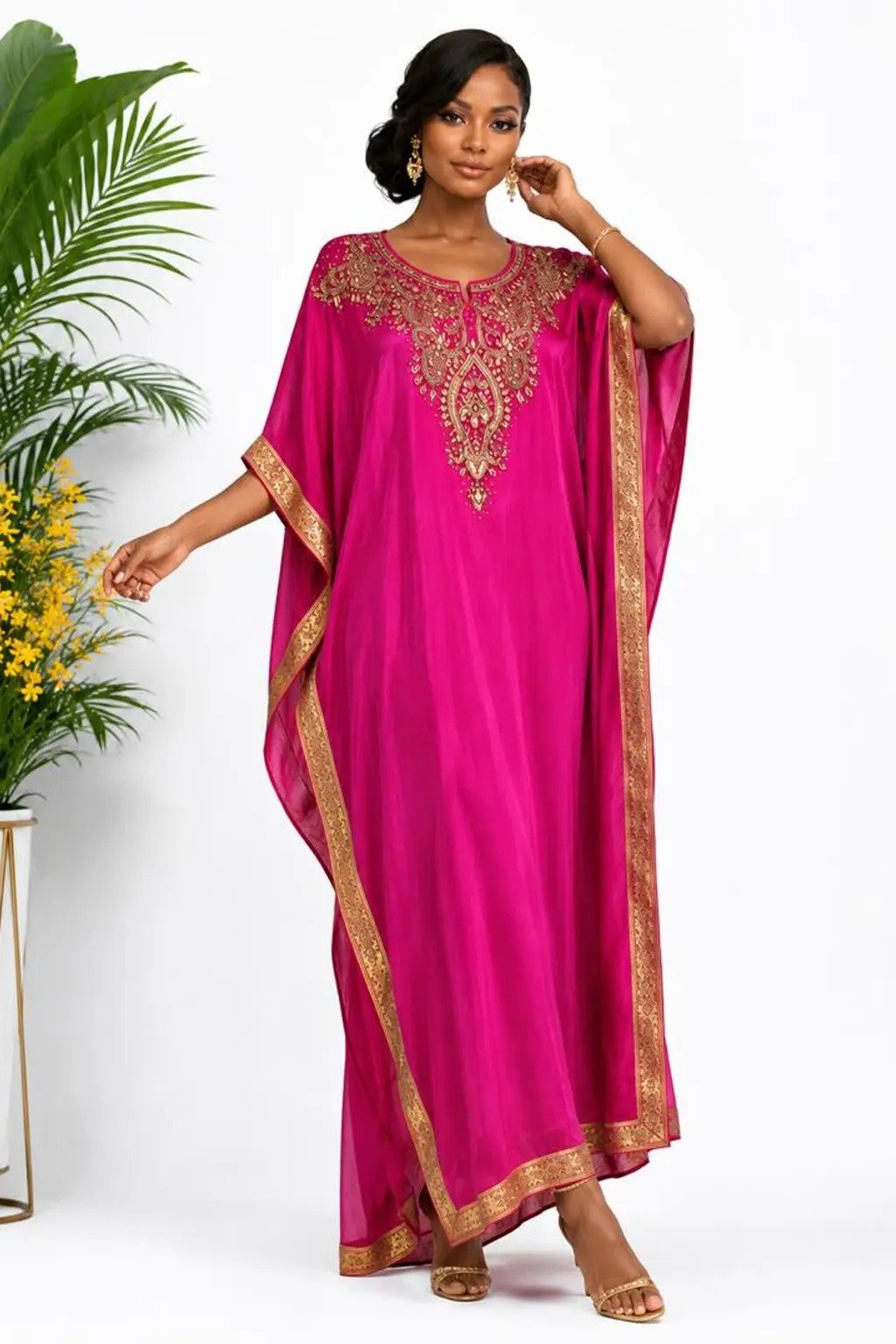 Woman wearing a magenta gold-embellished kaftan maxi gown