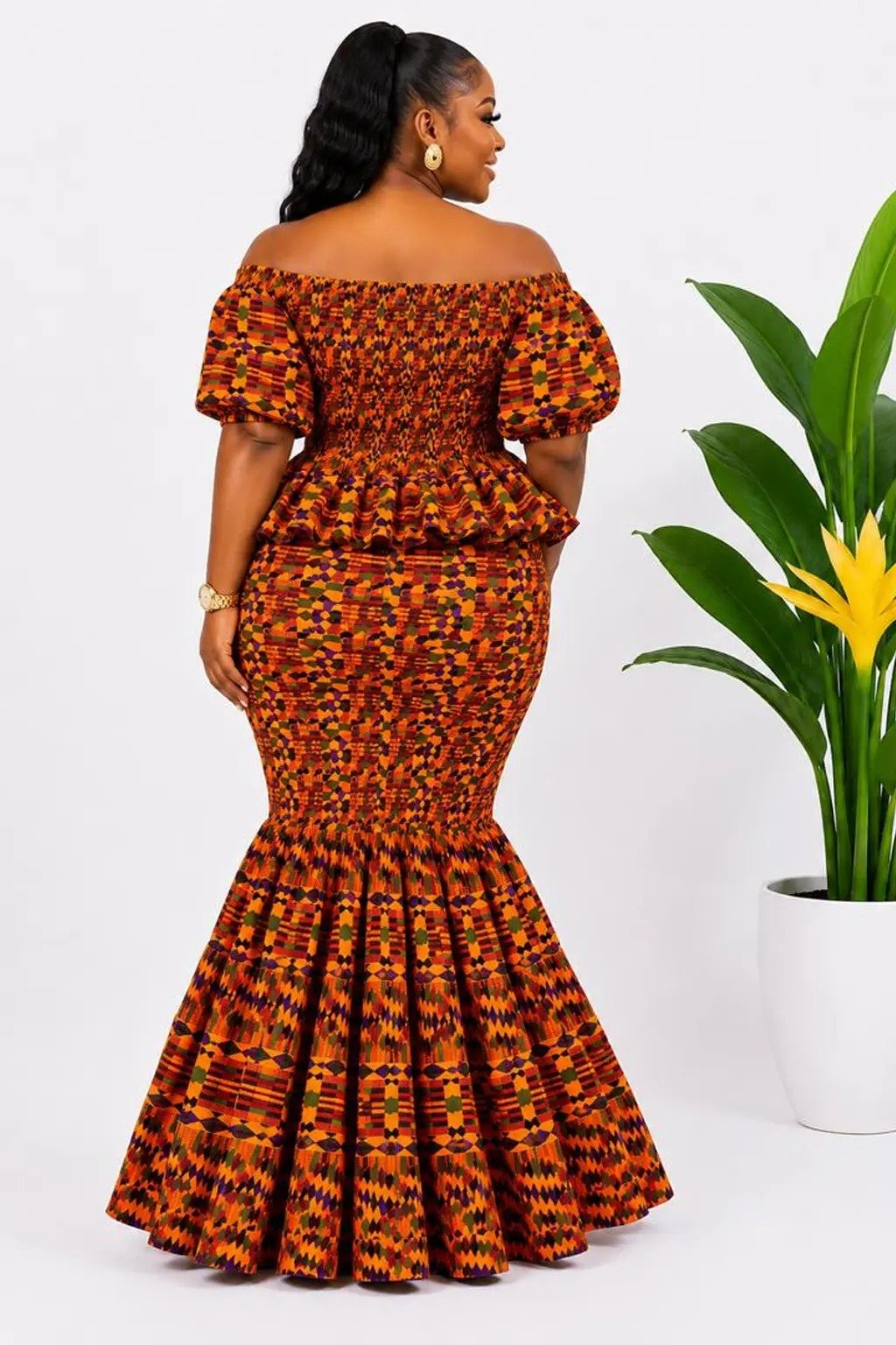 Orange Kente Off-Shoulder Peplum Mermaid Maxi Dress 2 Woman wearing an orange kente African print off-shoulder peplum mermaid maxi dress - view 2
