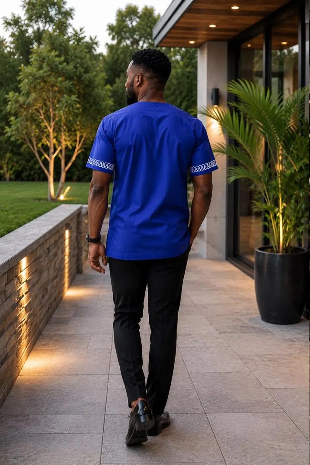 Royal Blue Embroidered African Print Men's Shirt 2 Man wearing a royal blue embroidered African print short-sleeve shirt - view 2