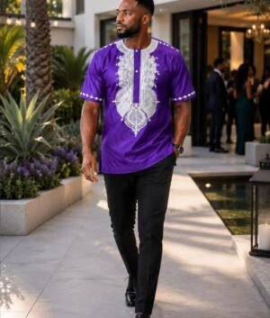 Man wearing a navy blue and gold embroidered African print short-sleeve shirt