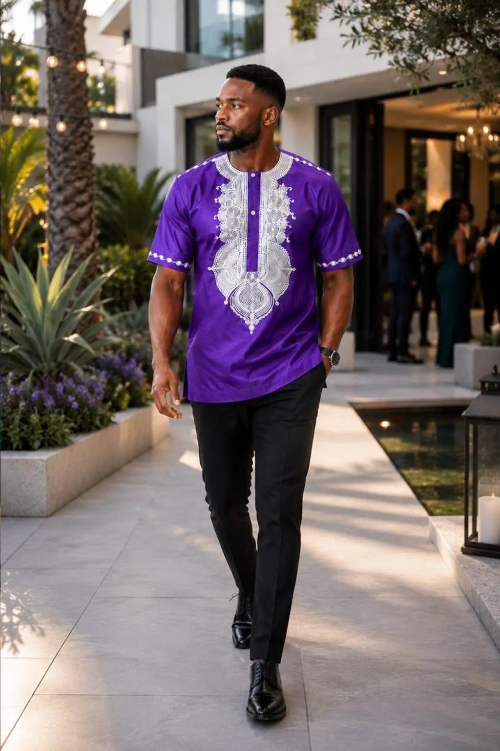 Man wearing a navy blue and gold embroidered African print short-sleeve shirt