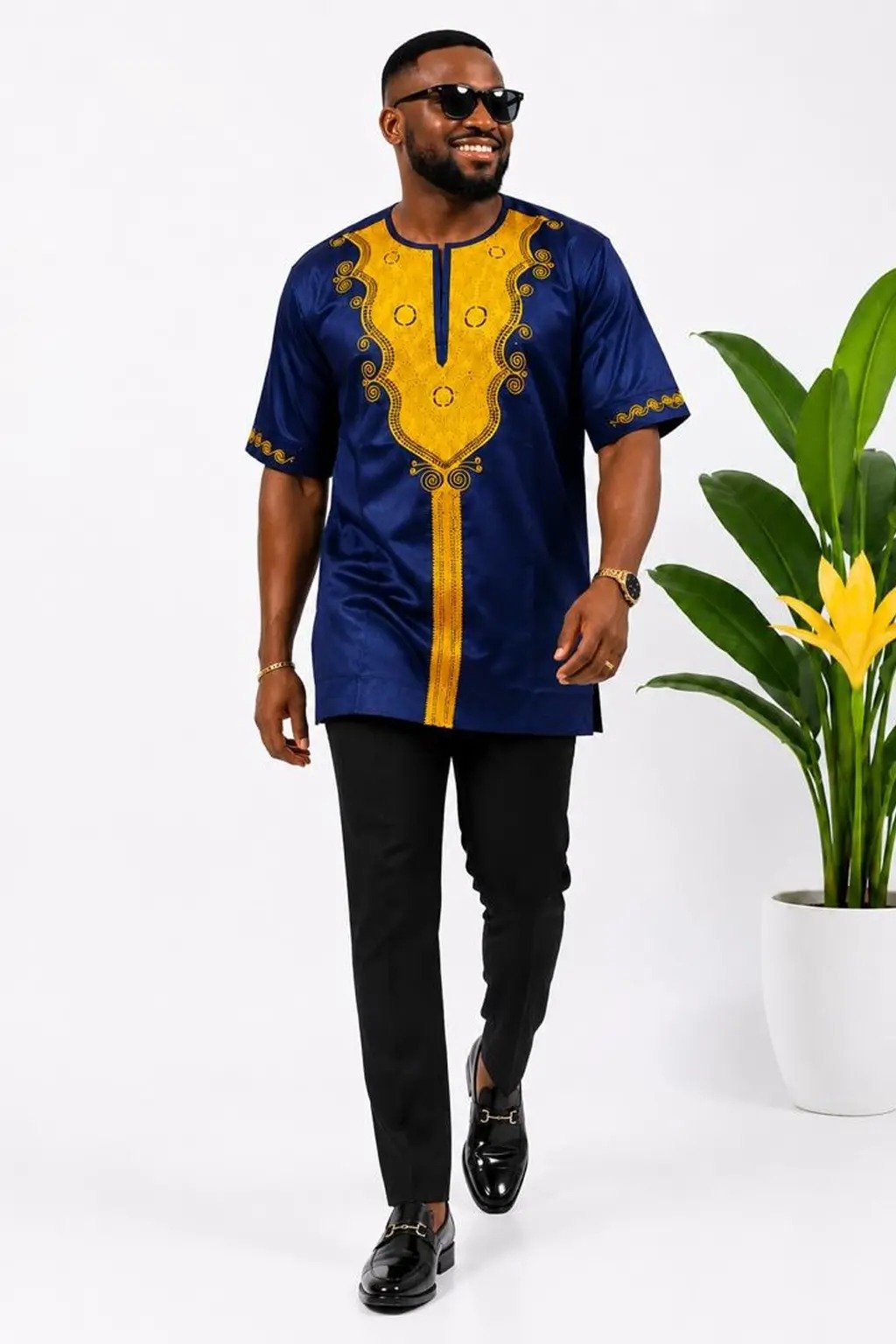 Man wearing a purple embroidered African print short-sleeve shirt