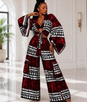 Woman modeling a luxury red and black African print two-piece co-ord set with a wide-sleeve tie-front kimono top and matching high-waisted wide-leg palazzo pants.