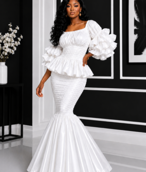 A Woman Wearing An Elastic Pearl White Smocked Peplum Top And Ruffle Mermaid Maxi Skirt Set.