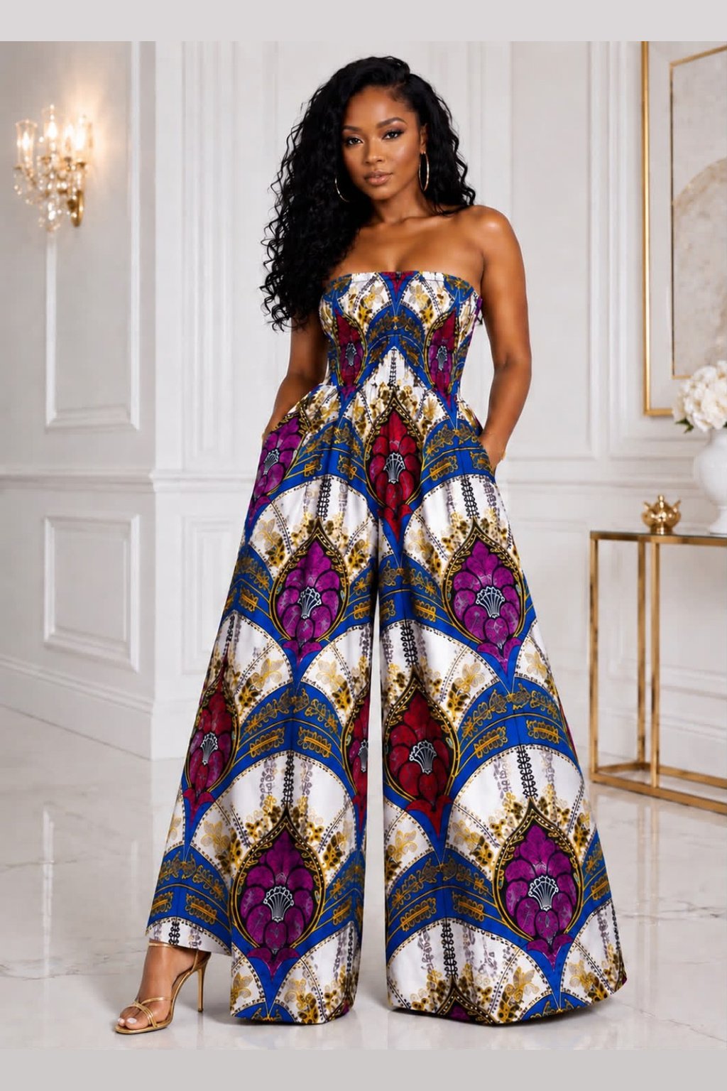 Woman Modelling An African Print Wide Leg Palazzo Romper. Vibrant Royal Blue and Purple Geometric Statement Bodysuit. Elegant Wedding Guest Outfit & Summer Streetwear. Strapless Ankara Jumpsuit with Pockets.