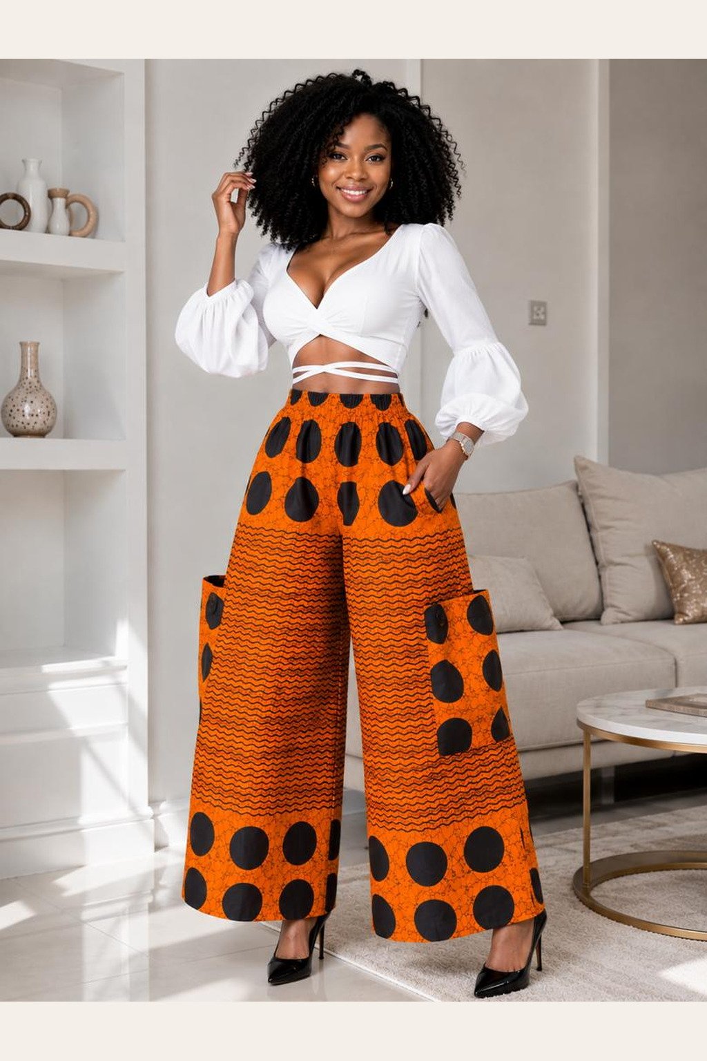 A Woman Wearing A Wide-Leg Ankara Pants – Orange and Black Polka Dot Geometric Palazzo Trousers.