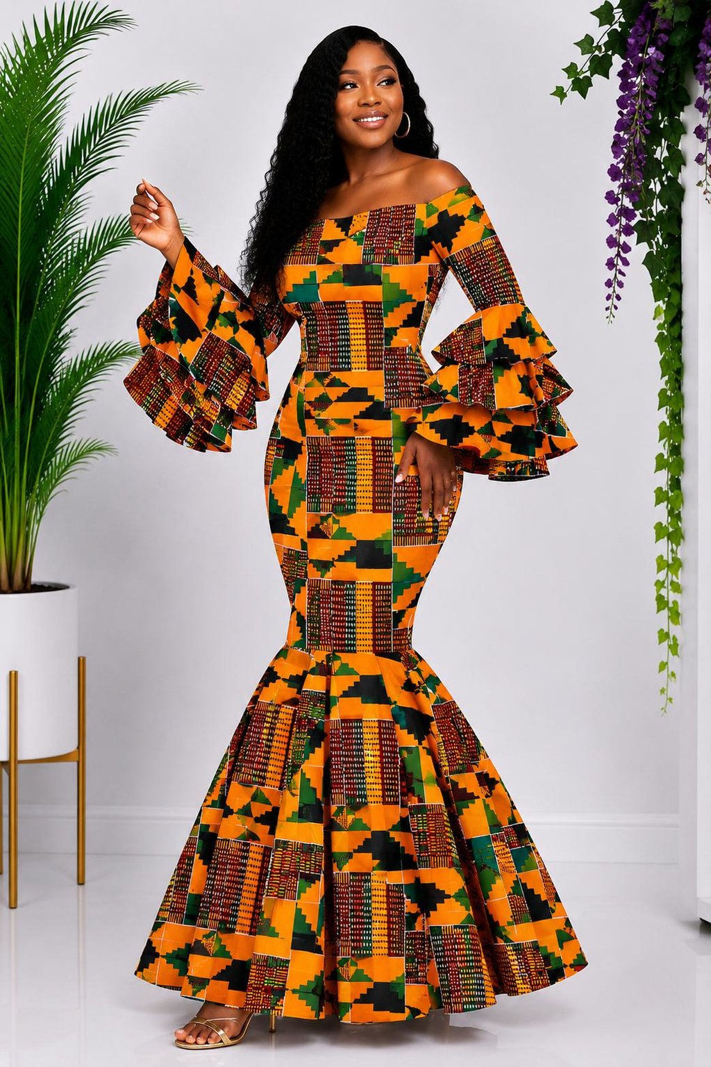 A Woman Wearing A Kente Mermaid Gown and Earth-Toned African Print Dress with Dramatic Tiered Ruffles