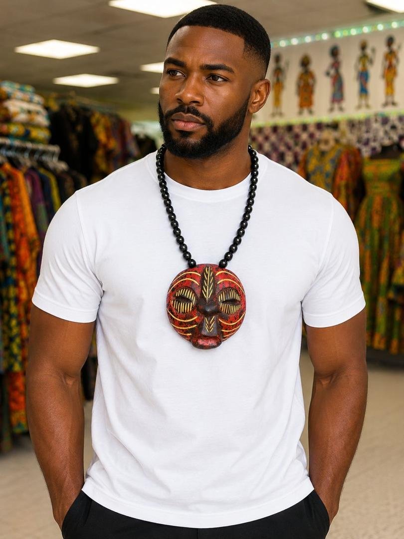 Hand Carved African Mask Necklace, Wooden Statement Pendant, Black Beaded Tribal Choker, Men Unisex Cowrie Shell Jewelry And Authentic Artisan Gift. 4 Man Wearing A Hand Carved African Mask Necklace, Wooden Statement Pendant, Black Beaded Tribal Choker, Men Unisex Cowrie Shell Jewelry And Authentic Artisan Gift.