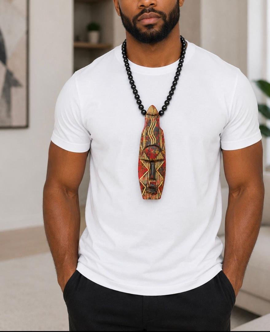 Hand Carved African Mask Necklace, Wooden Statement Pendant, Black Beaded Tribal Choker, Men Unisex Cowrie Shell Jewelry And Authentic Artisan Gift. 9 Man Wearing A Hand Carved African Mask Necklace, Wooden Statement Pendant, Black Beaded Tribal Choker, Men Unisex Cowrie Shell Jewelry And Authentic Artisan Gift.