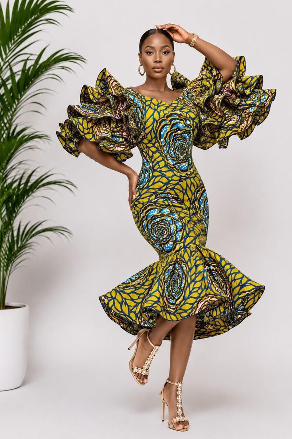 A Woman Wearing A Royal Rosette Ankara Multi-Tiered Ruffle Mermaid Midi Dress.