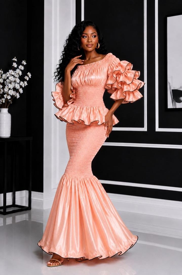 Elastic Luminous Peach Rose Gold Smocked Peplum Top & Ruffle Mermaid Maxi Skirt Set. 2 A Woman Wearing An Elastic Luminous Peach Rose Gold Smocked Peplum Top & Ruffle Mermaid Maxi Skirt Set.
