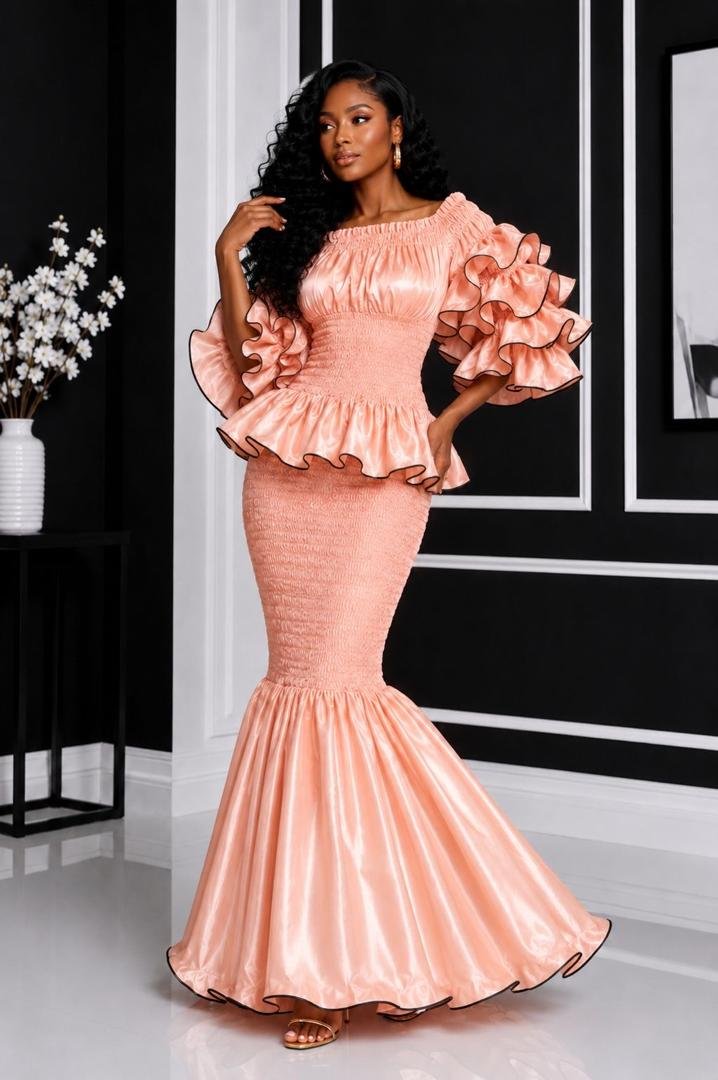 Elastic Luminous Peach Rose Gold Smocked Peplum Top & Ruffle Mermaid Maxi Skirt Set. 4 A Woman Wearing An Elastic Luminous Peach Rose Gold Smocked Peplum Top & Ruffle Mermaid Maxi Skirt Set.