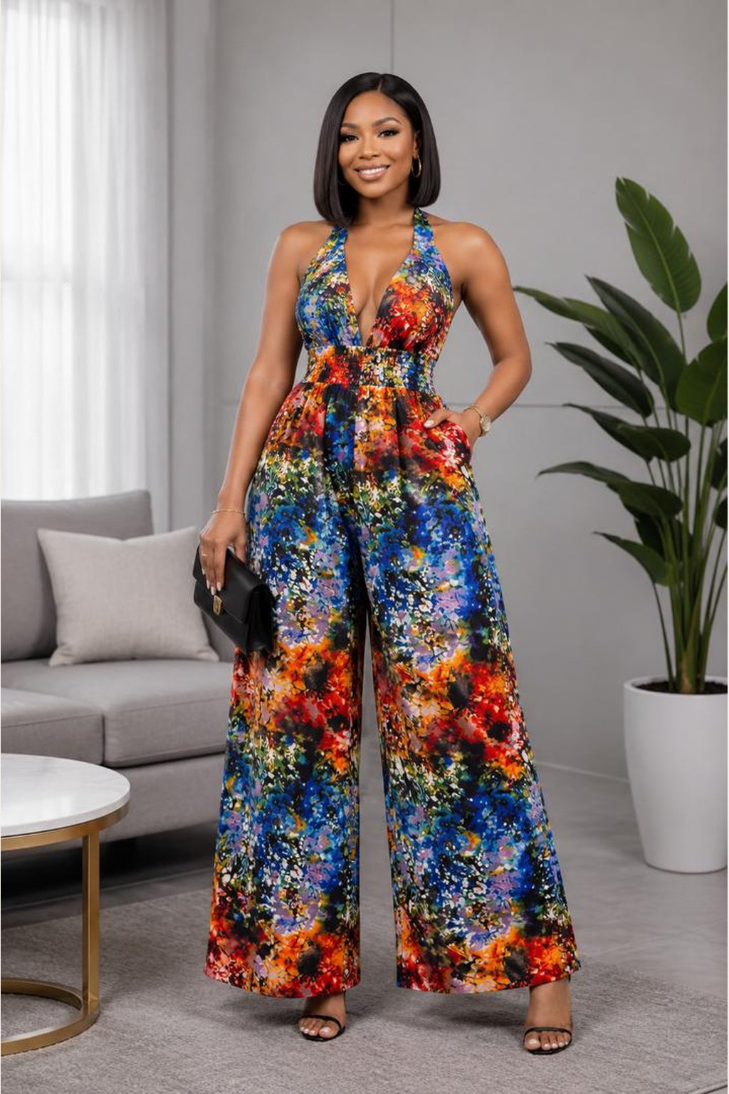 Woman Wearing A Aurora Wide-Leg Halter Jumpsuit – Vibrant Abstract Multi-Color Print with Pockets.