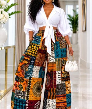 Woman Wearing An African Print Patchwork Wide Leg Pants Set, Ankara Cargo Trousers with White Wrap Crop Top And Multi Pattern Tribal Co-Ord Set.