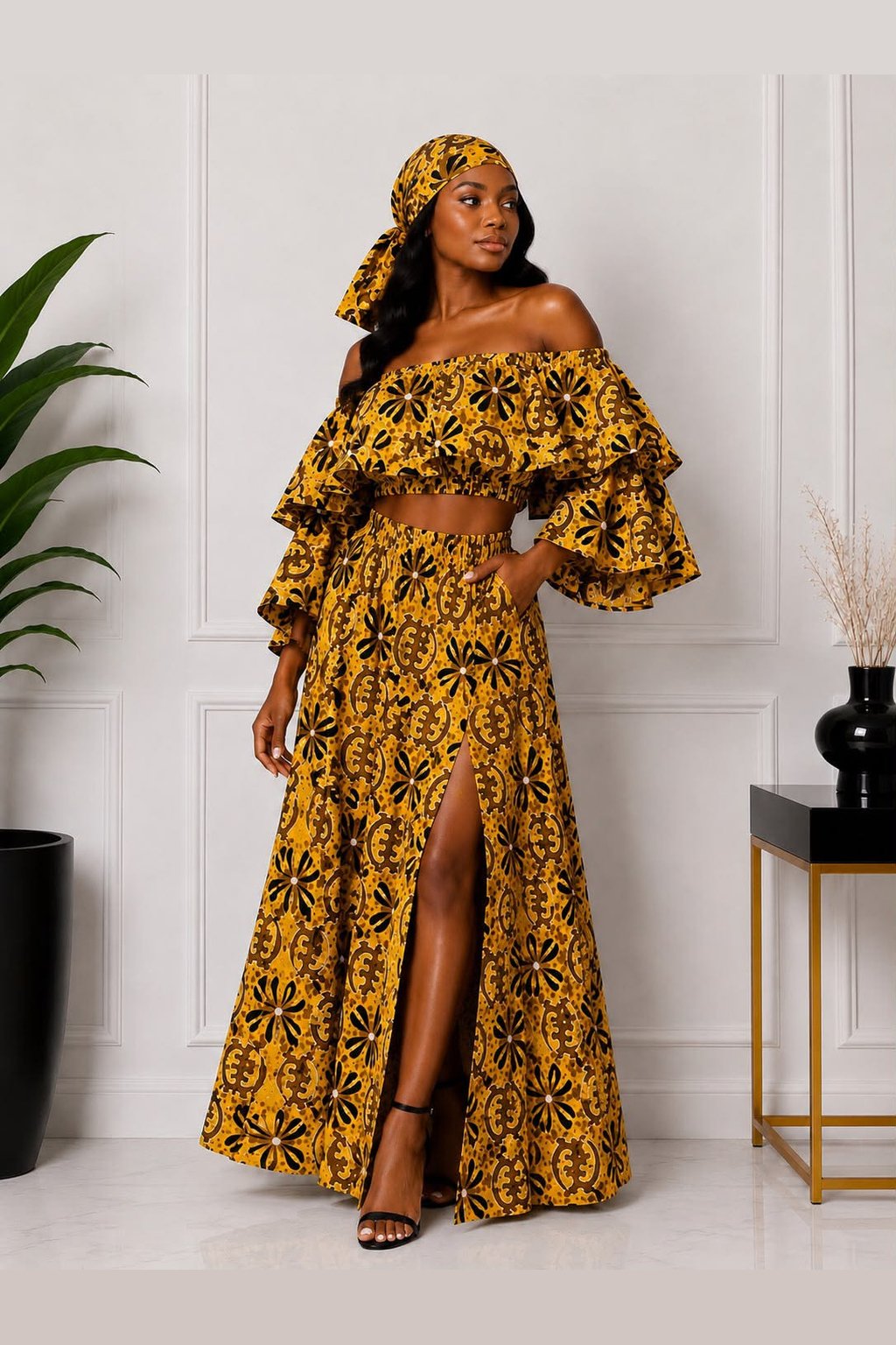 Woman Wearing A Luxury Ankara Print 3-Piece Maxi Set – Tiered Off-the-Shoulder Crop Top, High-Slit Skirt & Matching Headwrap.