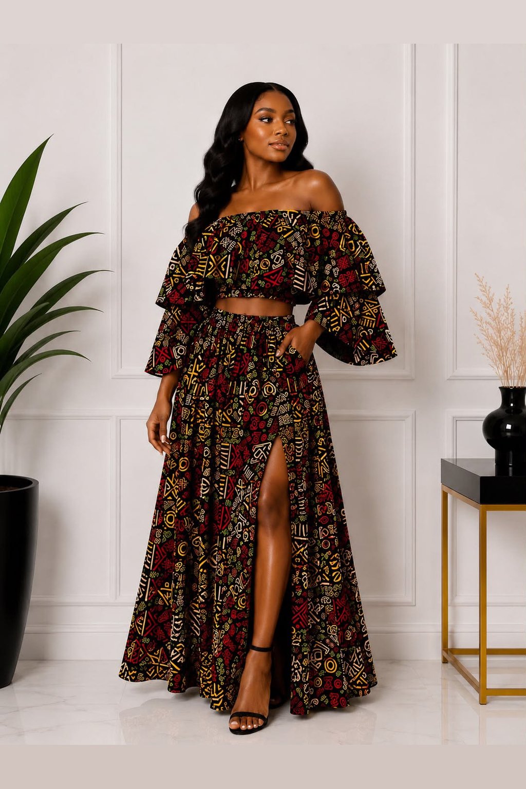 Women Wearing An African Print Off‑Shoulder Two‑Piece Set, Red, Yellow & Green Ankara Crop Top & Maxi Skirt